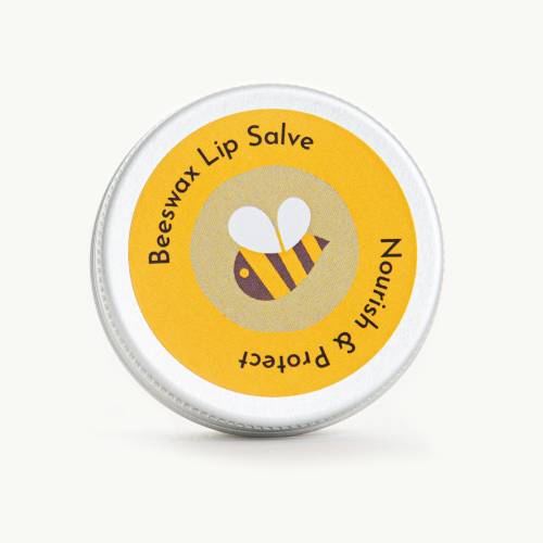 Photo shows a small tin of Beeswax Lip Salve with an illustration of a bee on the label